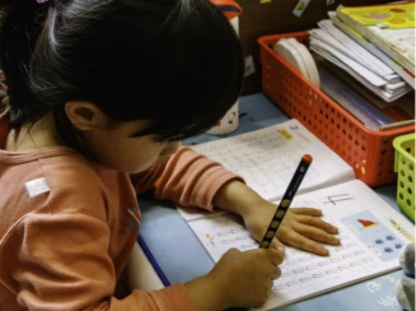 Oaks child learning to write image